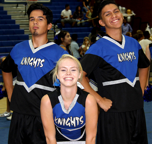 two male and one female cheerleader at pep rally